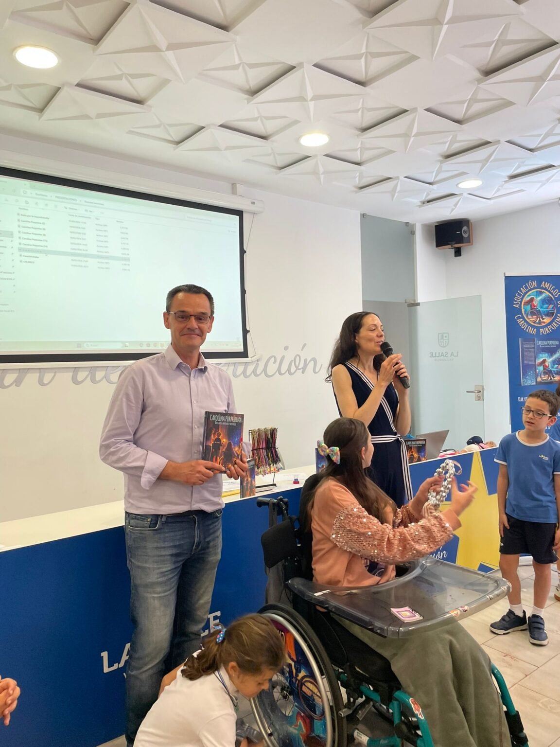 Présentation à La Salle Valladolid : Laura au micro pendant que le livre est montré aux élèves.